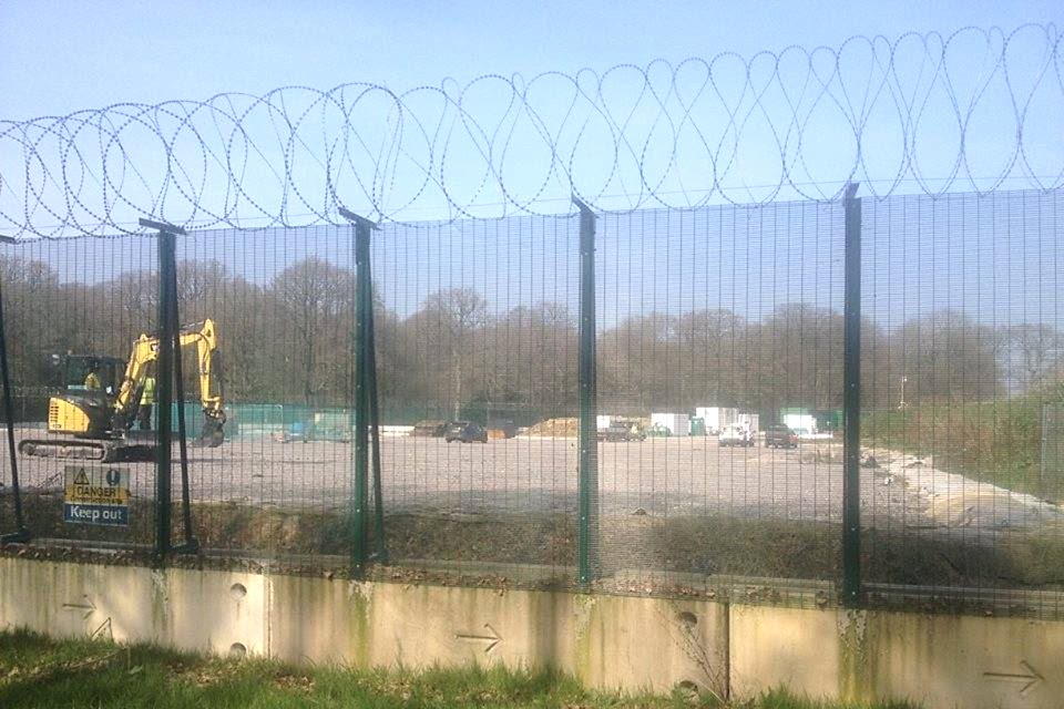 A machine is developing oils from the underground enclosed by 358 high security fence with a razor wire topping.