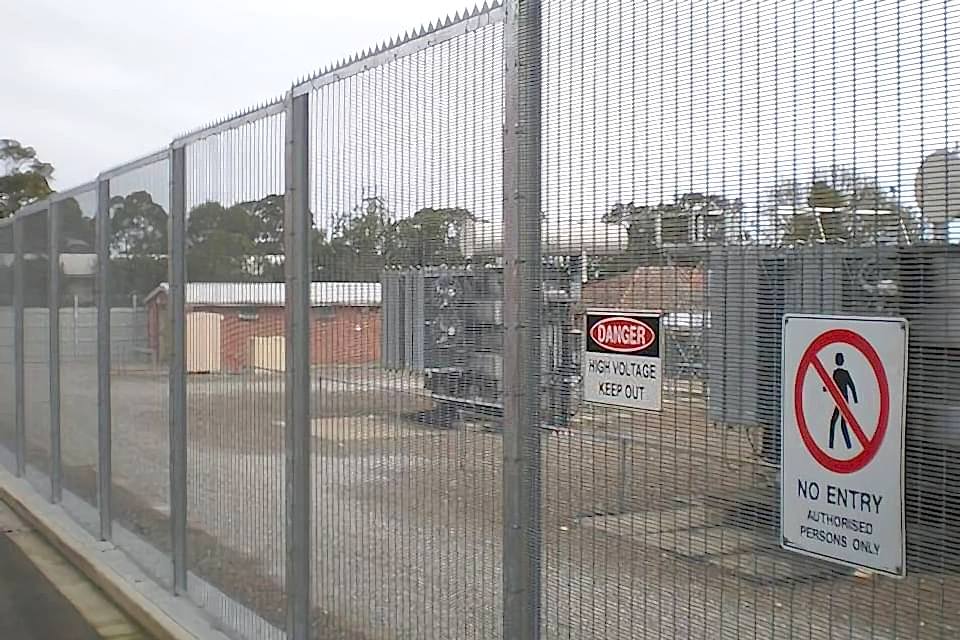 358 high security fence is equipped with spikes and two warning signs to protect electric installations there.