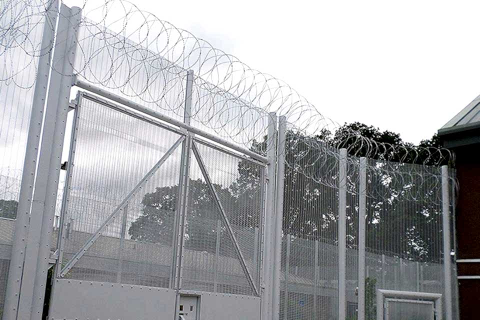 358 high security fence is equipped with a razor wire topping and serves as a prison fence gate.