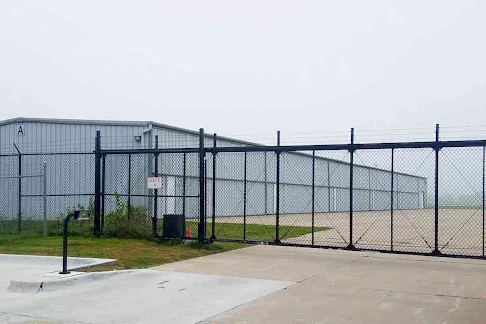 The workshop is encircled by chain link fence.