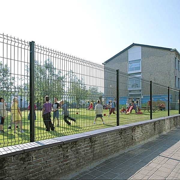 Many kids are playing around in the leisure park enclosed by curvy welded fence.