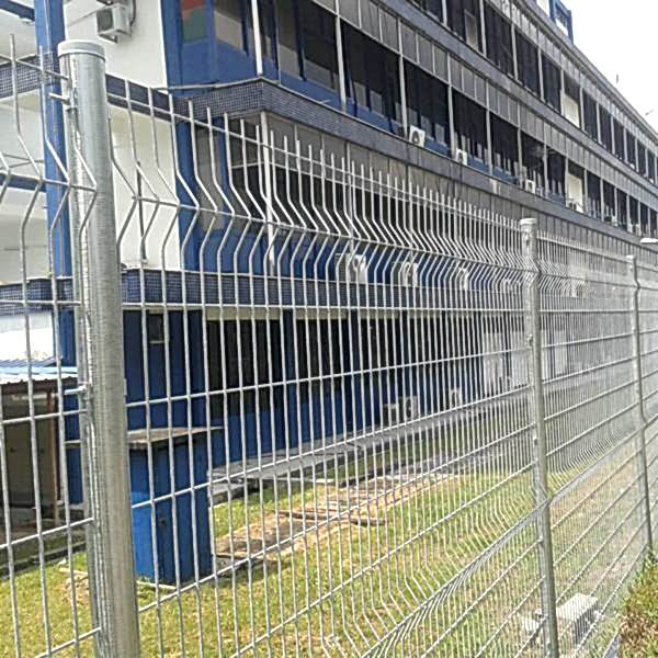 Curvy welded fence is used to create boundaries for office buildings.