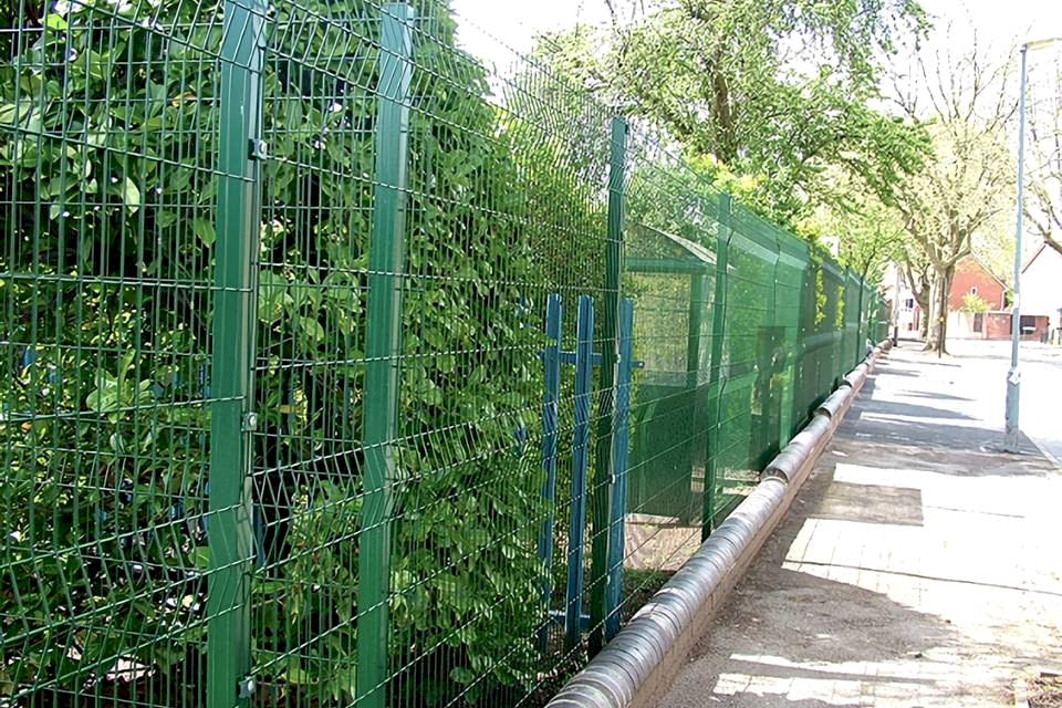 Curvy welded fence is installed along the botanical garden.