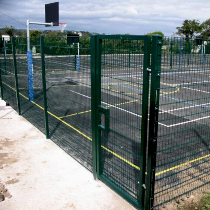 Double wire fence is used to create boundaries for basketball court.