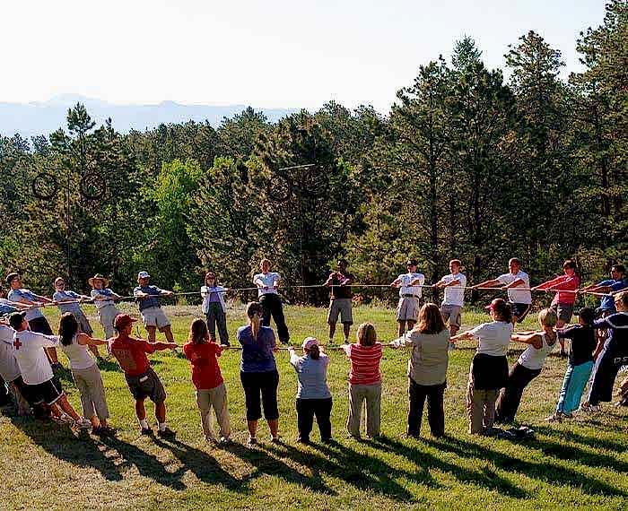 People are holding hands in a circle to do outdoor activity.