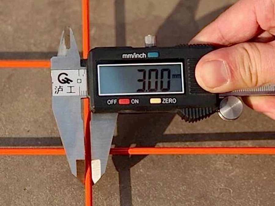 A man is measuring the wire diameter of Canada temporary fence.