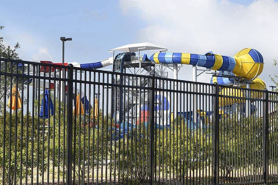 Amusement facilities are enclosed by steel fence.