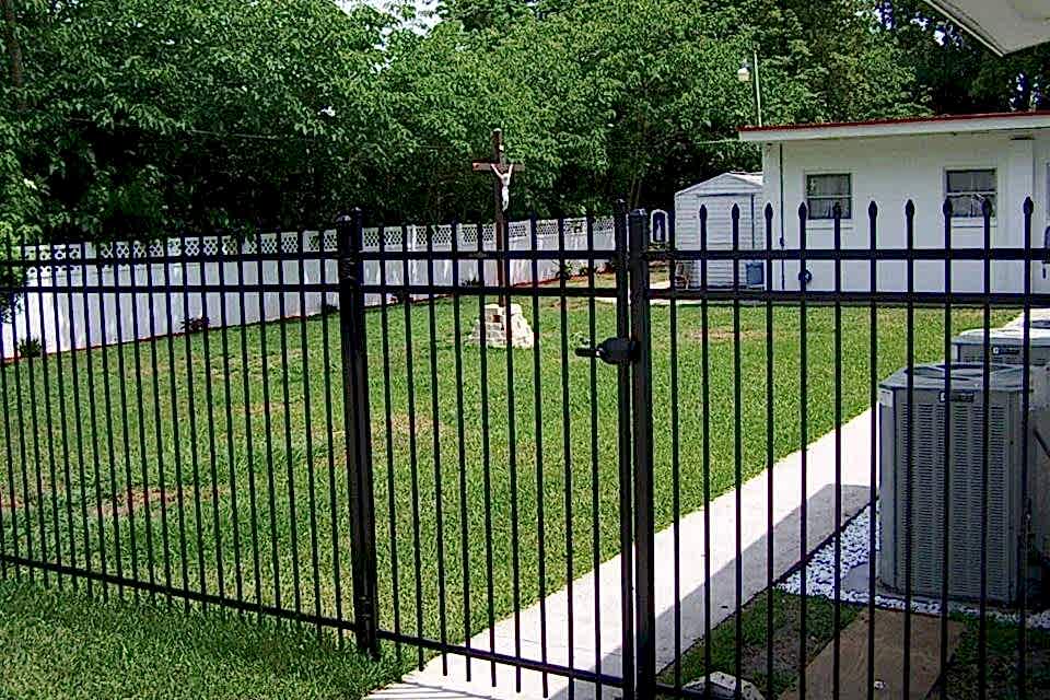 A private house is enclosed by steel fence with a fence gate.