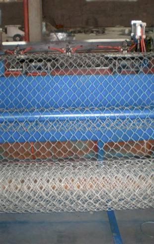 A weaving machine is producing chain link fence